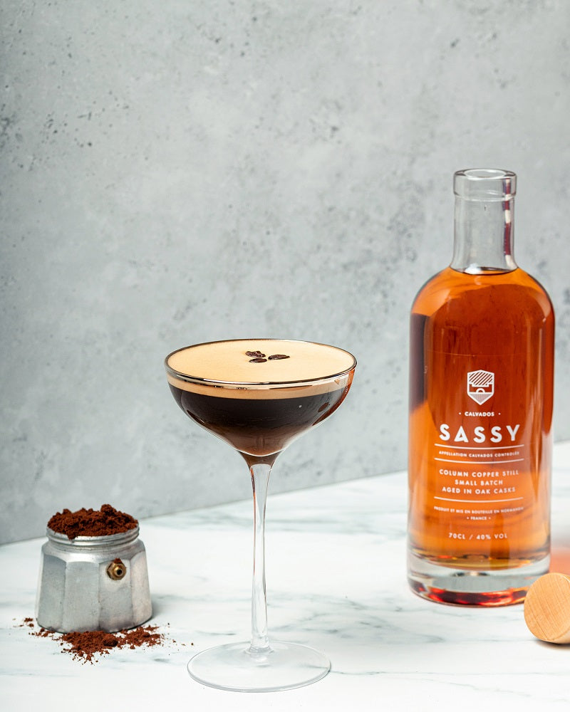 Calvados espresso martini next to bottle of Maison Sassy calvados