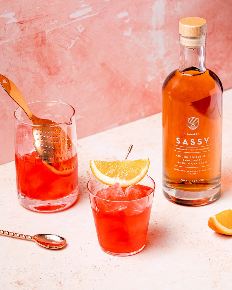 Maison Sassy calvados next to red calvados cocktail